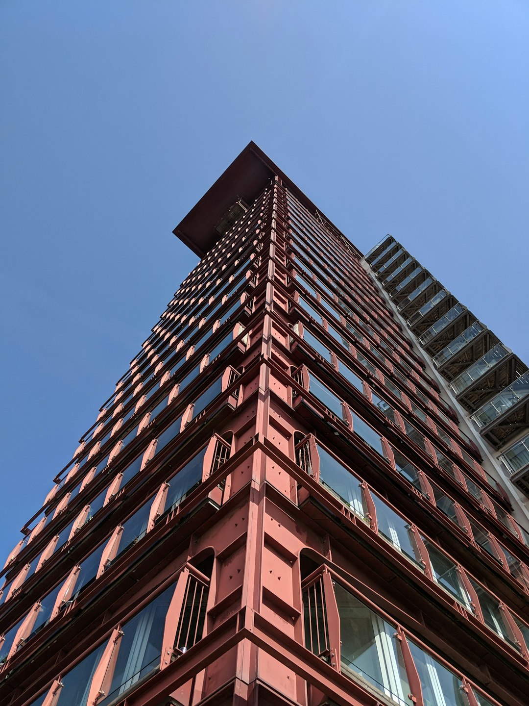 low angle photography of pink high-rise building