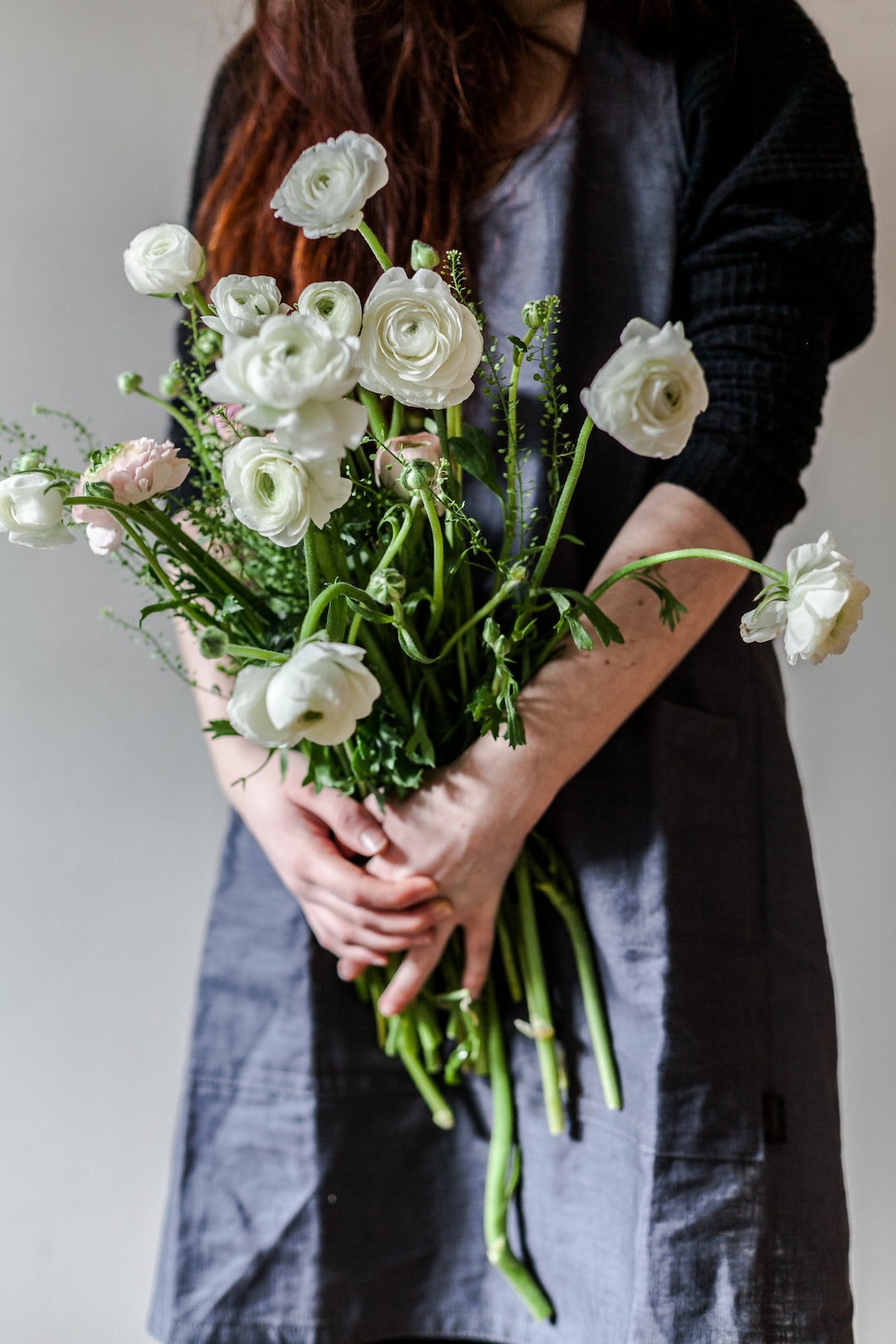 woman holding white roses
