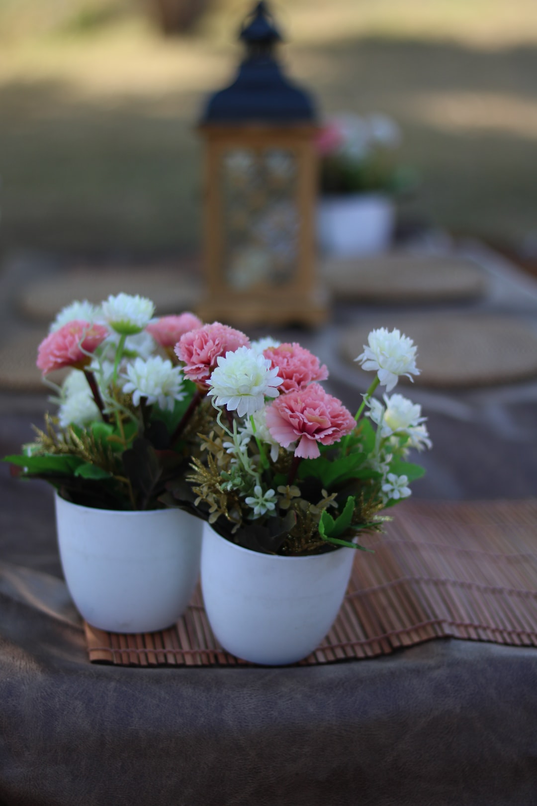 pink and white flowers in white ceramic vase