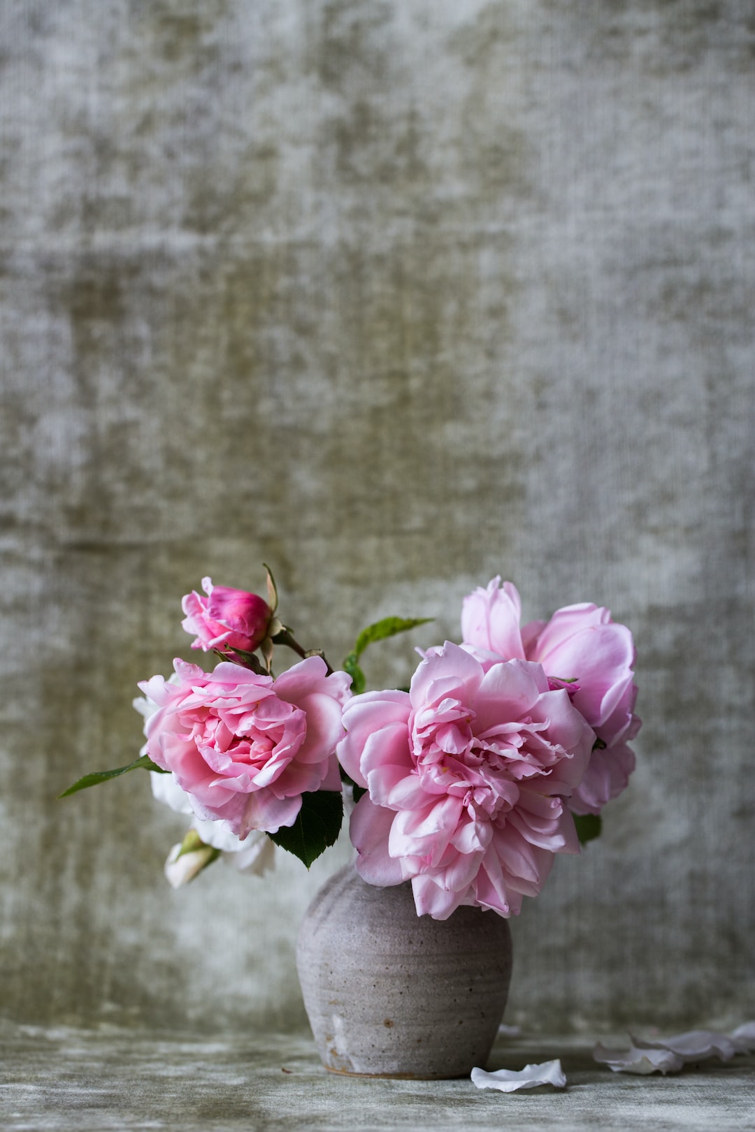 pink flowers on gray ceramic vase
