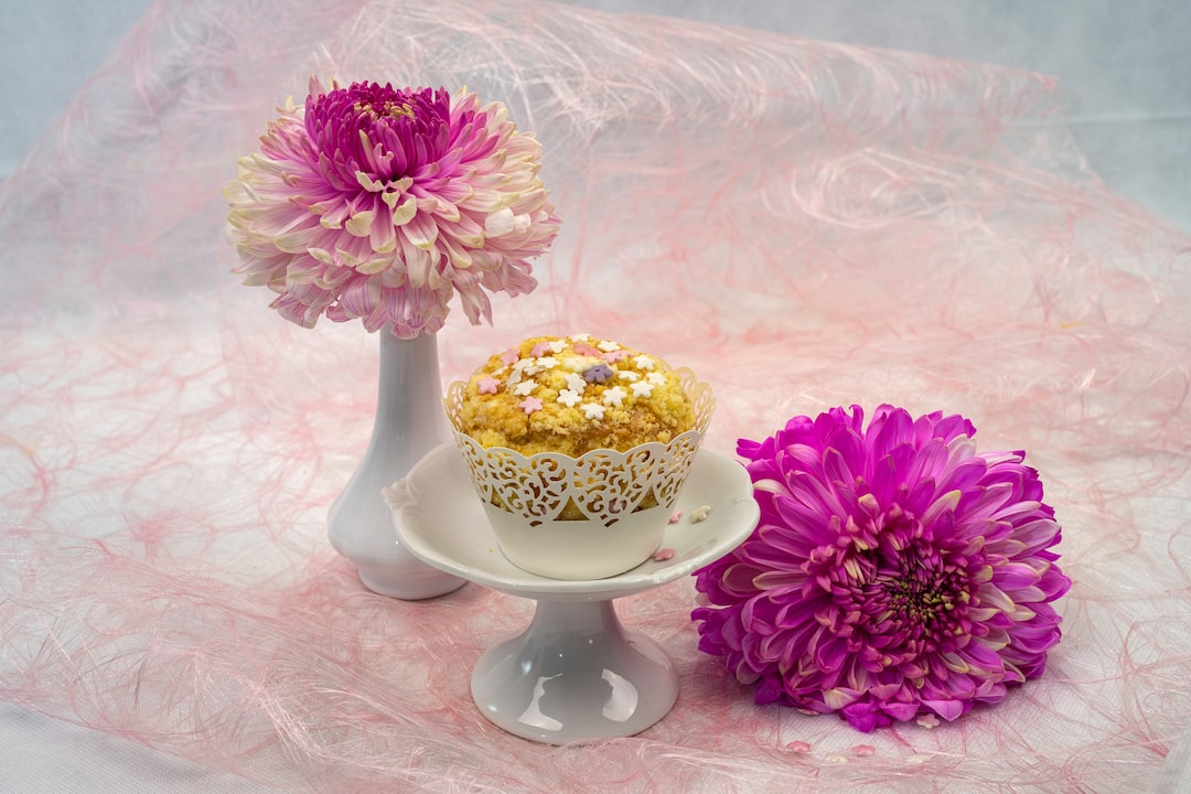 pink and yellow flowers in white ceramic vase